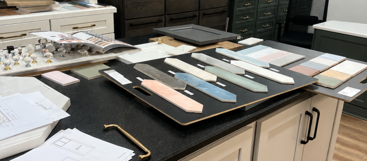 Cabinet door, tile, and hardware samples displayed in a design showroom.
