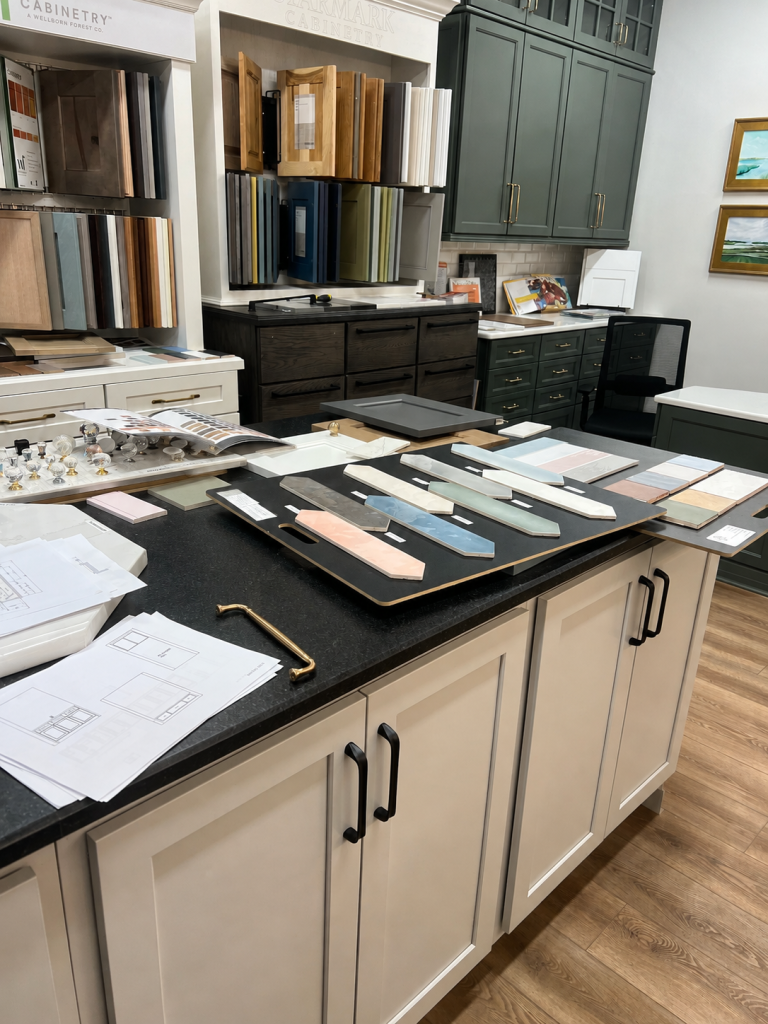 Cabinet door, tile, and hardware samples displayed in a design showroom.
