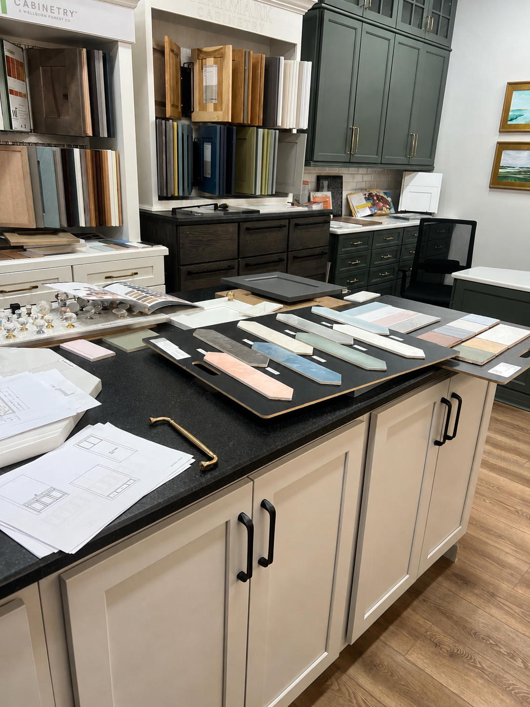 Cabinet door, tile, and hardware samples displayed in a design showroom.